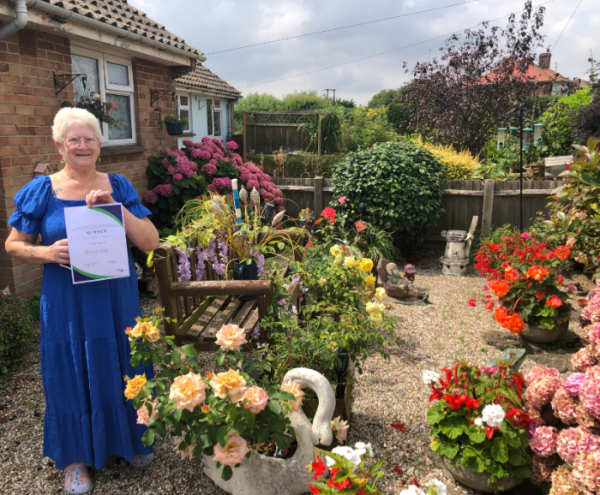 Florence Dray, one of the winners of the garden competition stands in her front garden