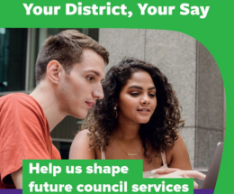 A man and woman pointing to a laptop computer screen. Wording on image reads Your District, Your Say. Help us shape future council services.
