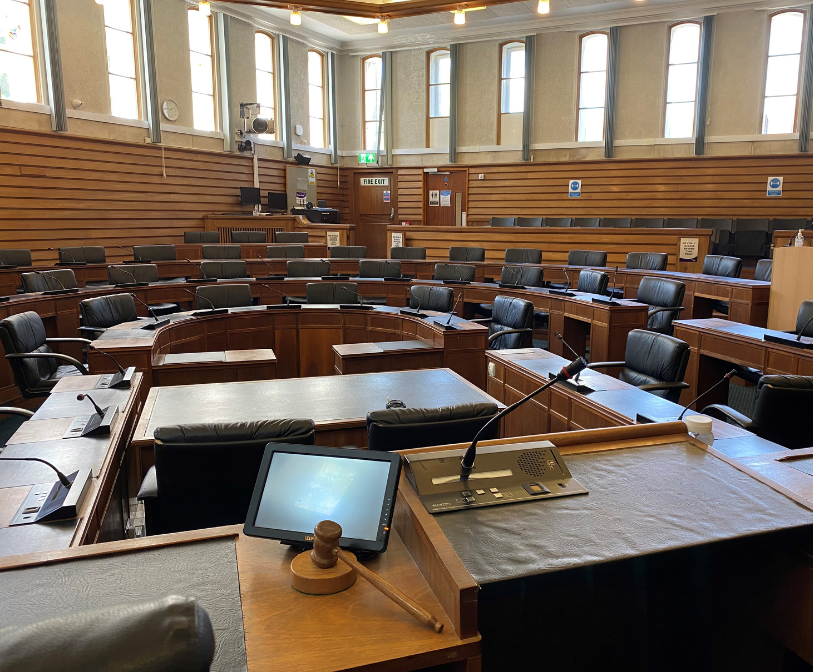 A photograph of an empty council chamber, from the chair&#039;s position, at the Civic Centre in Folkestone.