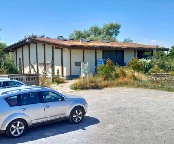 An image of the Romney Marsh Visitor Centre (RMVC) with views of the car park and green area