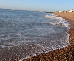 Sea breaking on the shingle shore at Hythe.